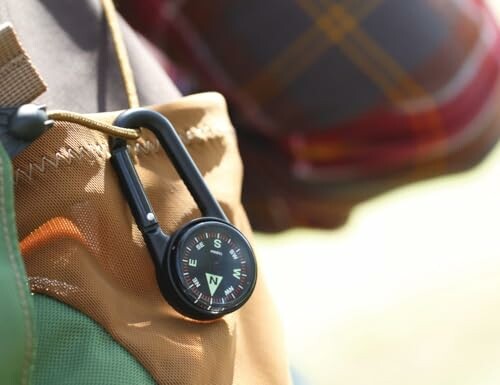 Compass clip attached to a backpack