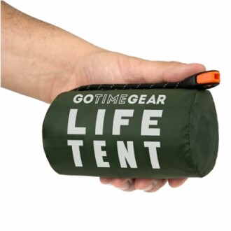 Hand holding a compact GoTimeGear Life Tent.