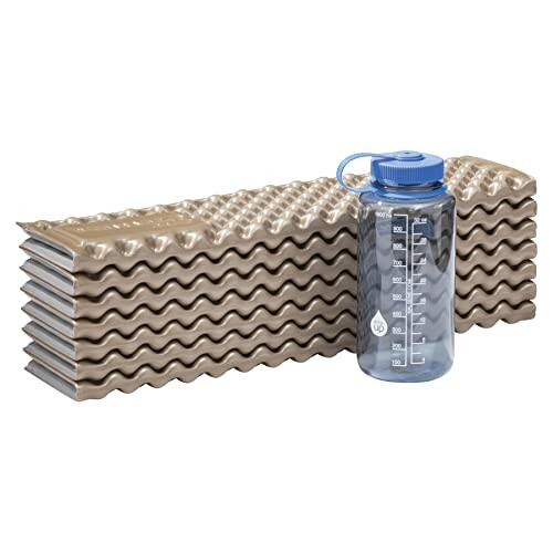 Foldable sleeping pad with a water bottle next to it.